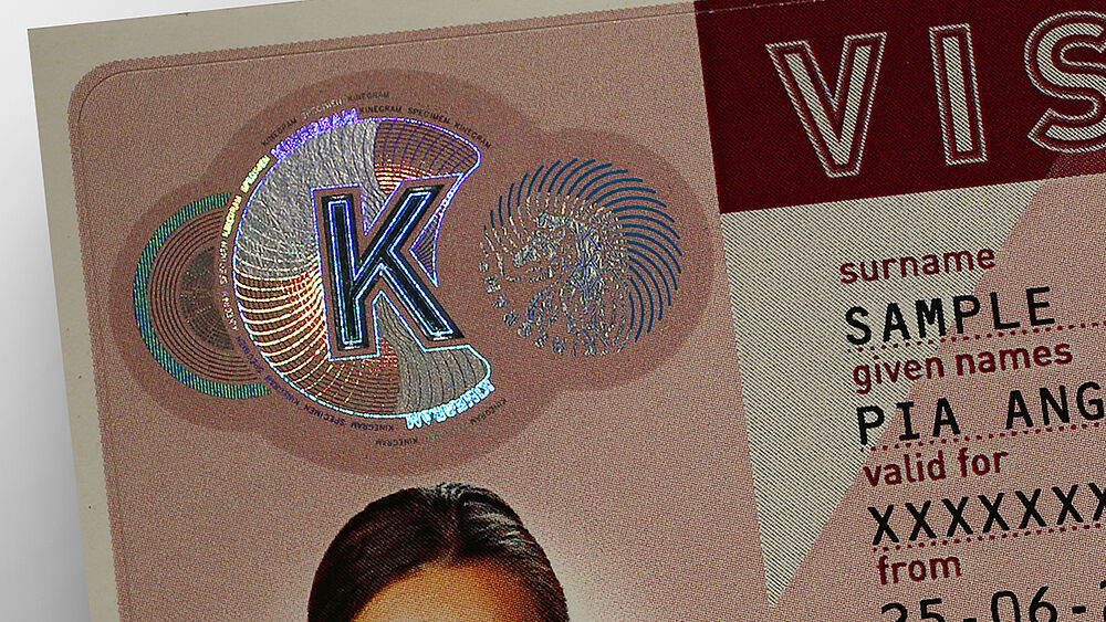 Detail of KINEGRAM PRIME security patch for visa stickers Close-Up of KINEGRAM sample security patch for protecting visa stickers showing a circular design combining metallized and printed lines