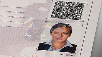 Close-up of a paper certificate that is protected by a KINEGRAM patch and a secure Visible Digital Seal barcode 