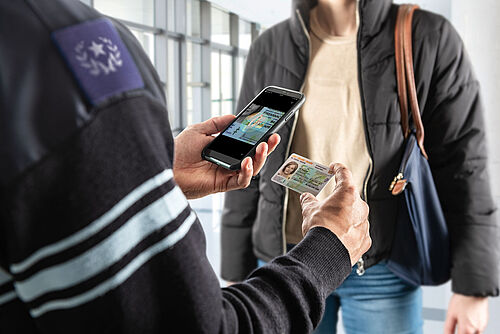 Mobile ID Document Verification Officer authenticating an identity document with his smartphone